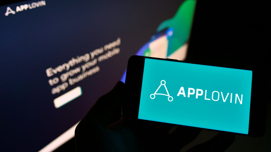 Applovin logo opened on a mobile phone and monitor