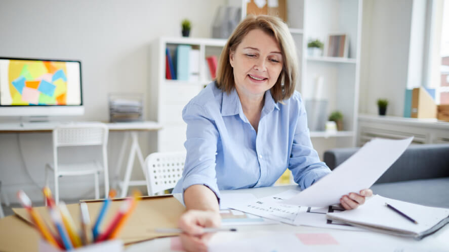 A publisher reading the contract before signing for grants