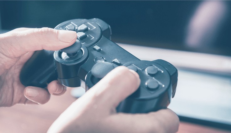A hand holding a game controller to test the game