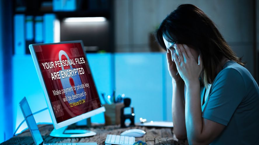 A depressed woman with her hacked and encrypted computer