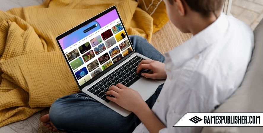 Person browsing indie games on a laptop while sitting on a couch, exploring various game titles on a colorful online platform.