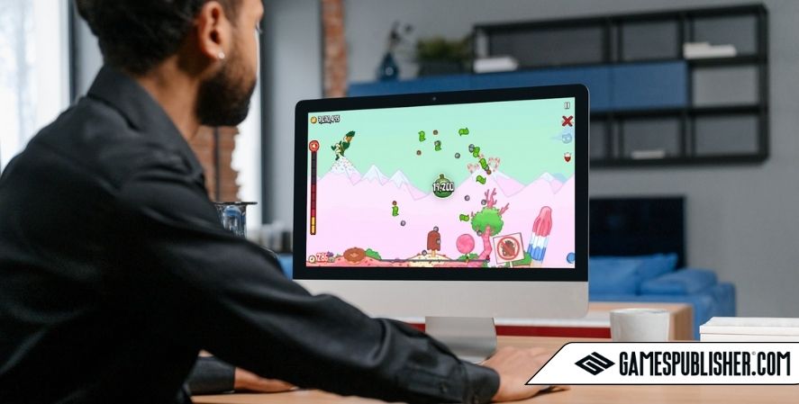 Man playing Burrito Bison: Launcha Libre on a desktop computer, launching a character through a colorful candy-themed level.
