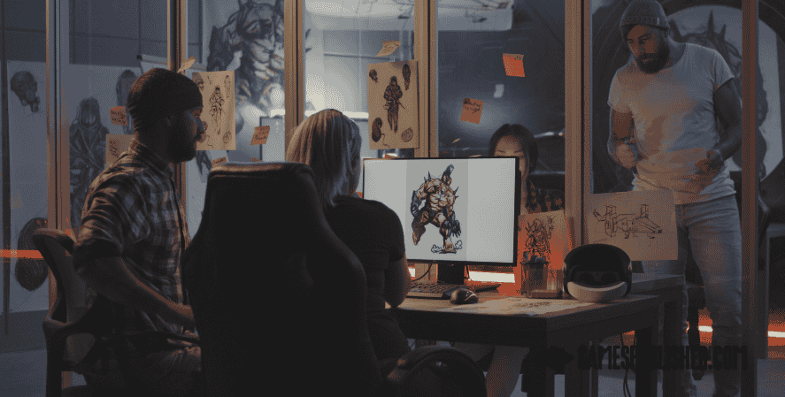 Game developers collaborating in a studio, reviewing character design art on a computer during indie game production.