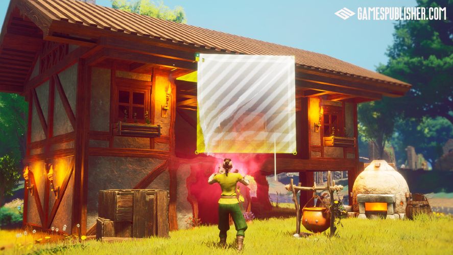 Third-person gameplay screenshot from RuneScape: Dragonwilds showing a character using magic to place a wall segment onto a timber-framed wooden house, with a cooking pot, stone oven, and wooden crates sitting in the grassy yard outside.